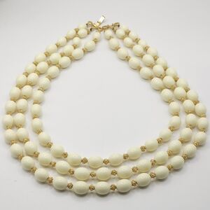 Vintage TRIFARI triple stranded‎ cream acrylic necklace with gold-toned spacers